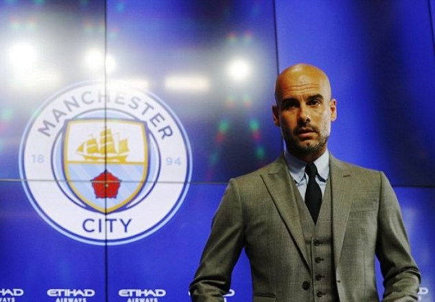 Pep Guardiola prepares to address journalists at Etihad during his first press conference since his arrival at the club