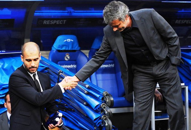 Pep (left) reluctantly greets Mourinho in a previous El Clasico match at the Santiago Bernabeu