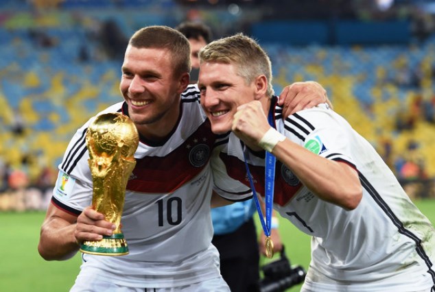 Podolski (left) and Bastian celebrate winning the 2014 World Cup in Brazil