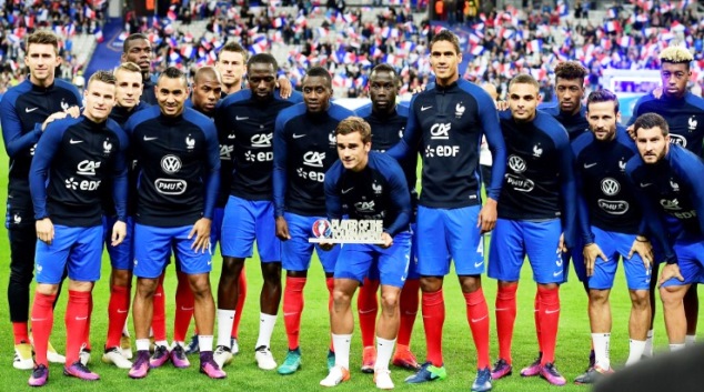 The Frenchman poses with the award alongside his teammates before kick-off
