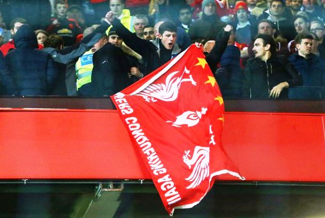 Manchester United fans clash with a Liverpool fan (holding a flag) during their Europa League quarter-final match at Old Trafford last season