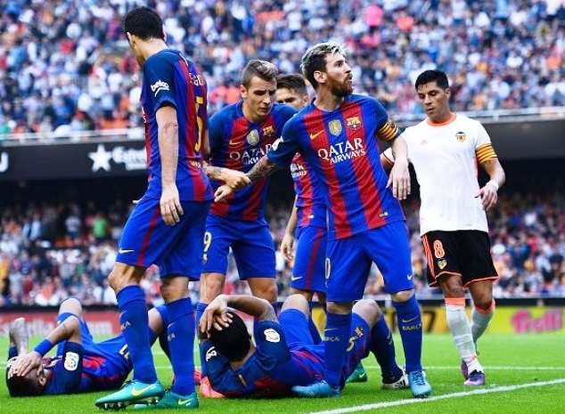 Messi realizes that the weather has changed. It is raining bottles. Two of his teammates have dropped to the ground.