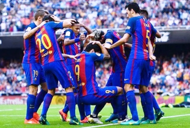 Barcelona players celebrate Lionel Messi's winner