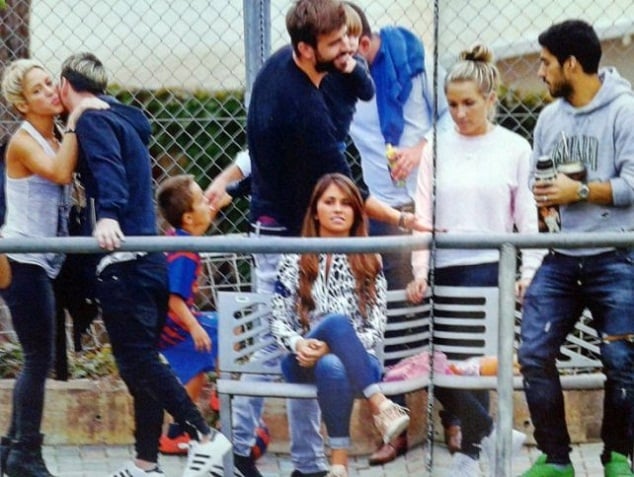 Shakira and Messi (far left) greet each other as Pique meets Suarez and his girlfriend. Roccuzzo is sitting on the bench, looking awkward. 