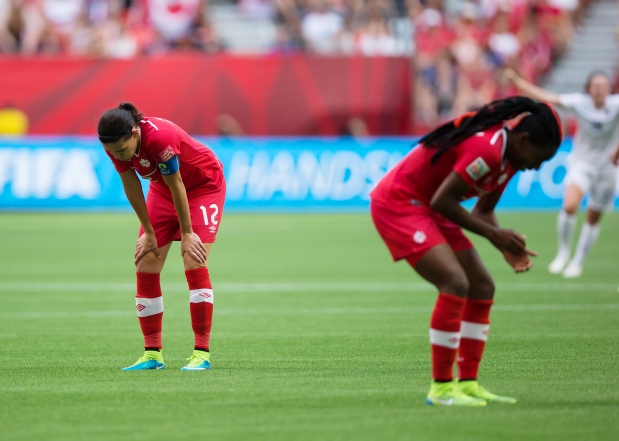 Christine Sinclair and Kadeisha Buchanan dejected following Canada's heartbreaking 2-1 defeat to England at the 2015 FIFA Women's World Cup.