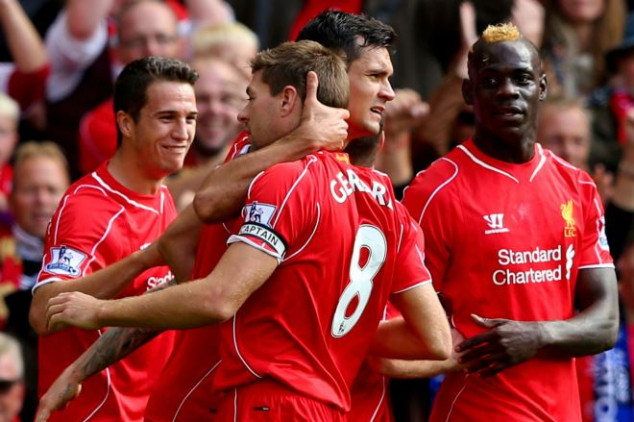 Steven Gerrard of Liverpool celebrating a goal with Balotelli and the rest of the team.