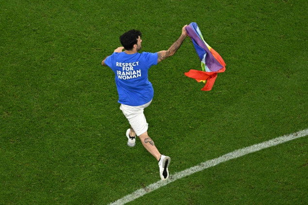 Man with rainbow flag invades pitch during World Cup game