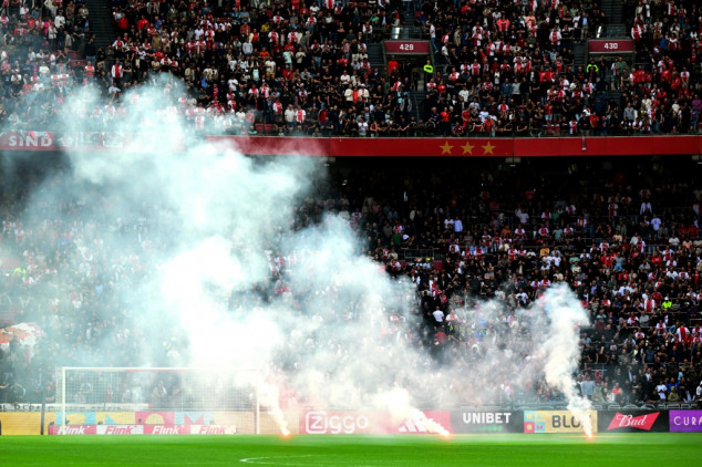 Ajax-Feyenoord scrapped after flares thrown on pitch, violence erupts